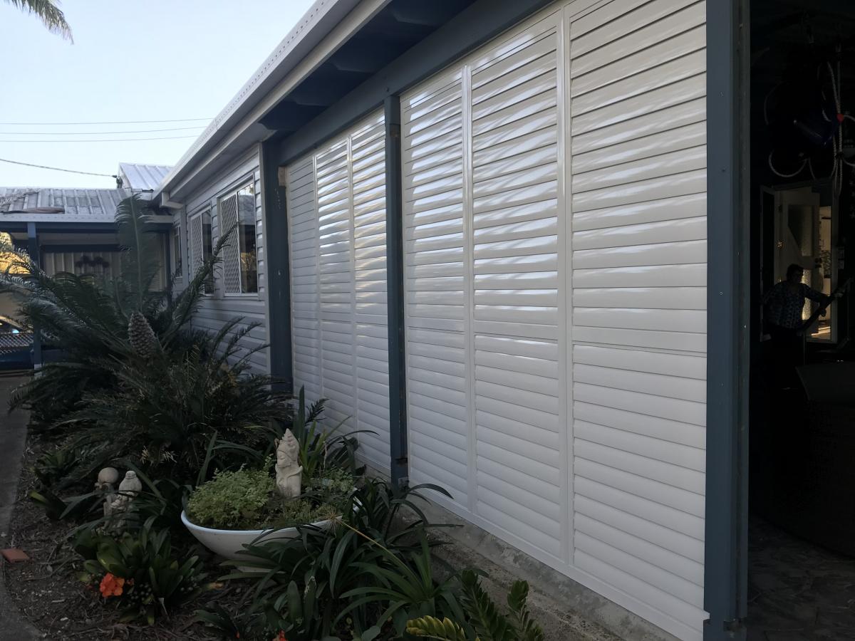 Infinity Shutters in color white acting as a wall for the house