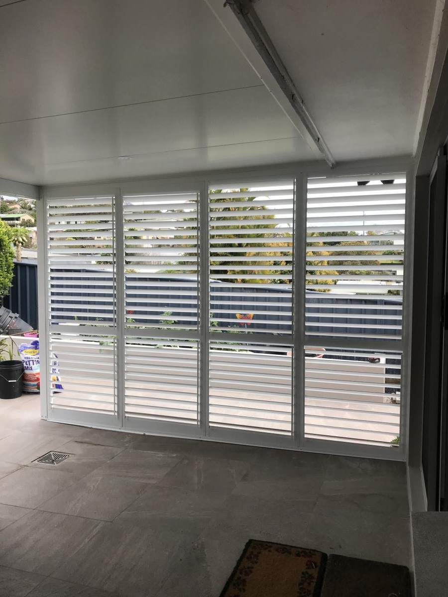 Plantation Shutters in white in the front porch