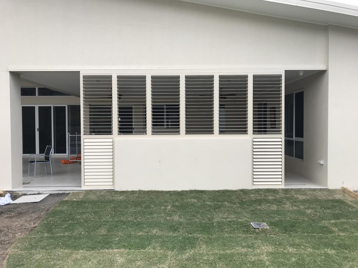 White Infinity Plantation Shutters installed and acting as wall