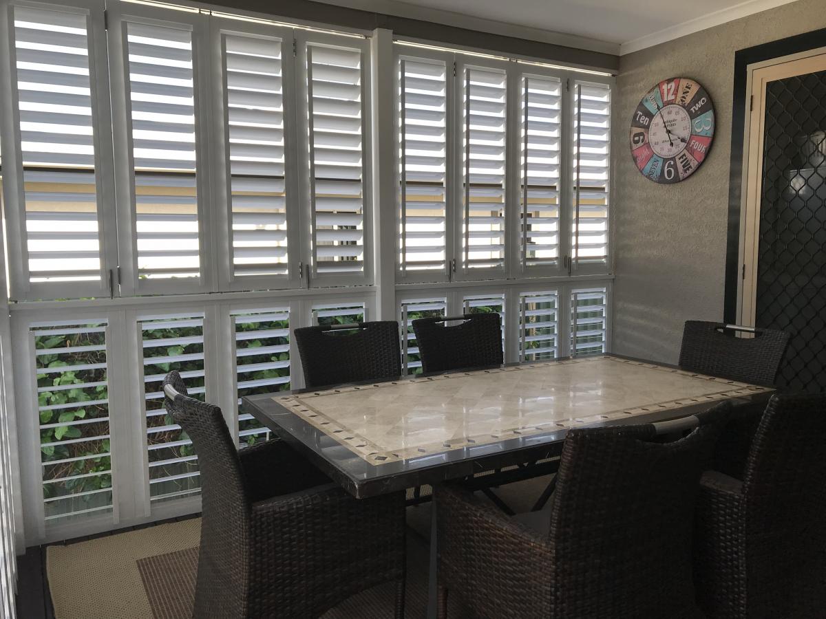 Infinity Plantation Shutters in the dining room installed as a wall